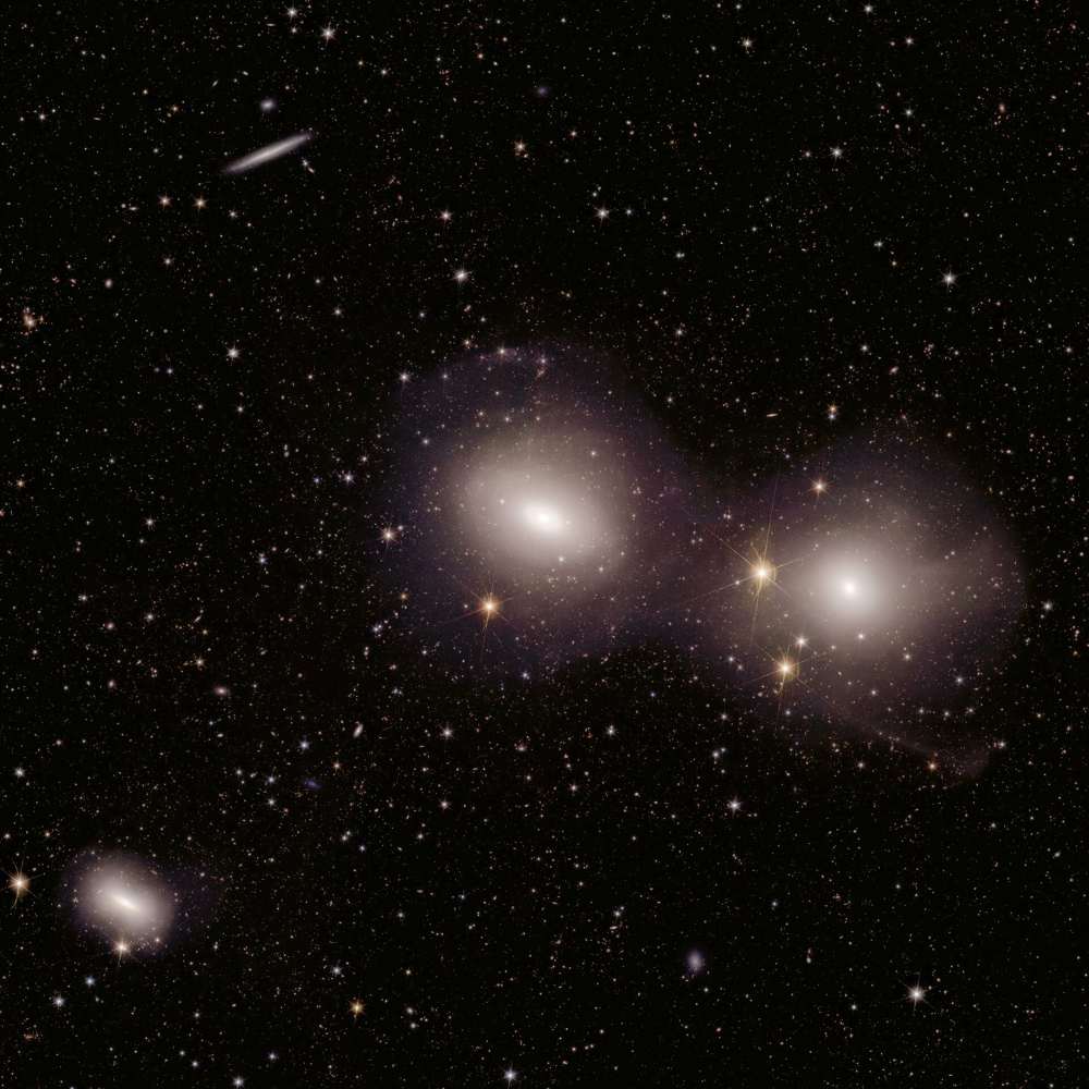 Deep-field image of the Dorado Group showing multiple elliptical galaxies, including dominant central members surrounded by smaller galaxies in a loose galactic cluster.