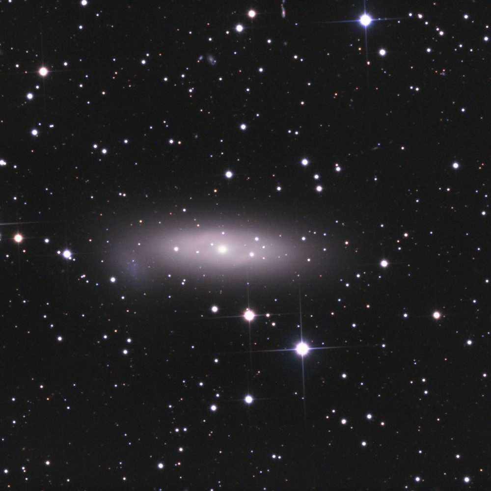 Image of NGC 1023, a lenticular galaxy and central member of the NGC 1023 Group, showing a smooth light profile and faint companion galaxies in a sparsely populated field.