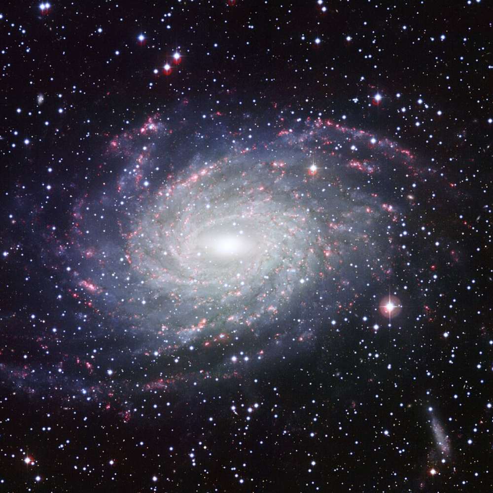 High-resolution image of NGC 6744, a barred spiral galaxy similar to the Milky Way, with distinct spiral arms and bright core.