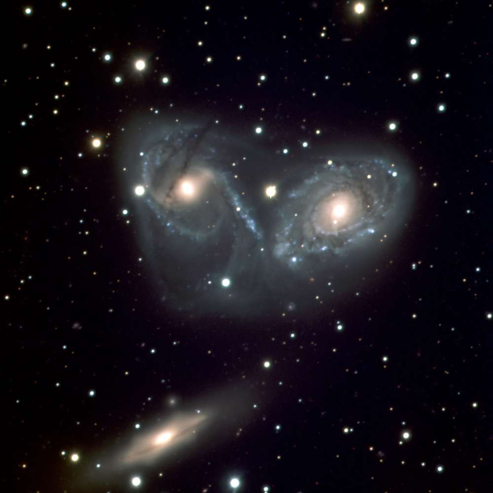 Color image of the NGC 6769 Group showing three interacting spiral galaxies—NGC 6769, NGC 6770, and NGC 6771—engaged in a gravitational dance, with visible tidal features and overlapping halos.