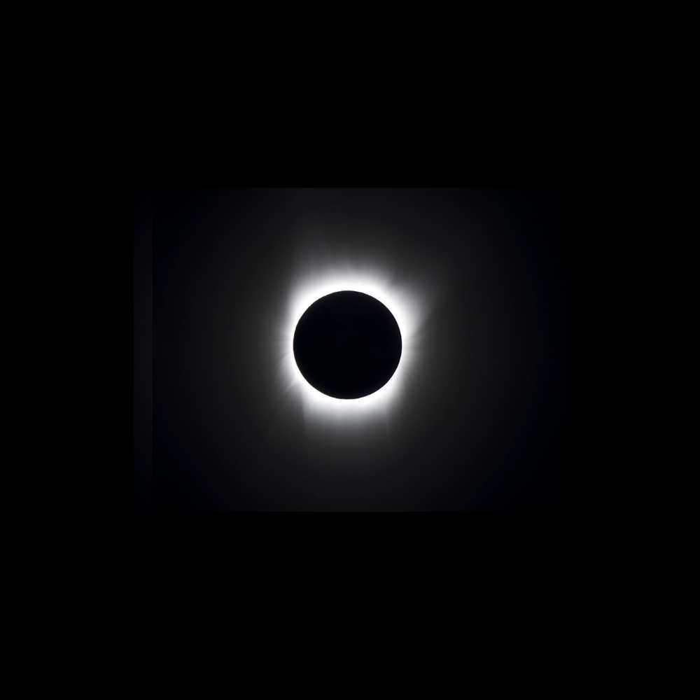 Symbolic representation of the Taurus Void as a blacked-out celestial region with a glowing corona, capturing the concept of cosmic emptiness and gravitational isolation.
