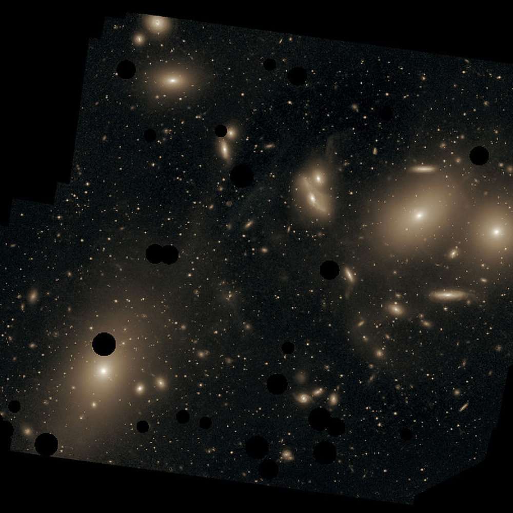 High-resolution image of the Virgo Cluster's central region showing dominant elliptical galaxies like M87 surrounded by numerous satellite galaxies.