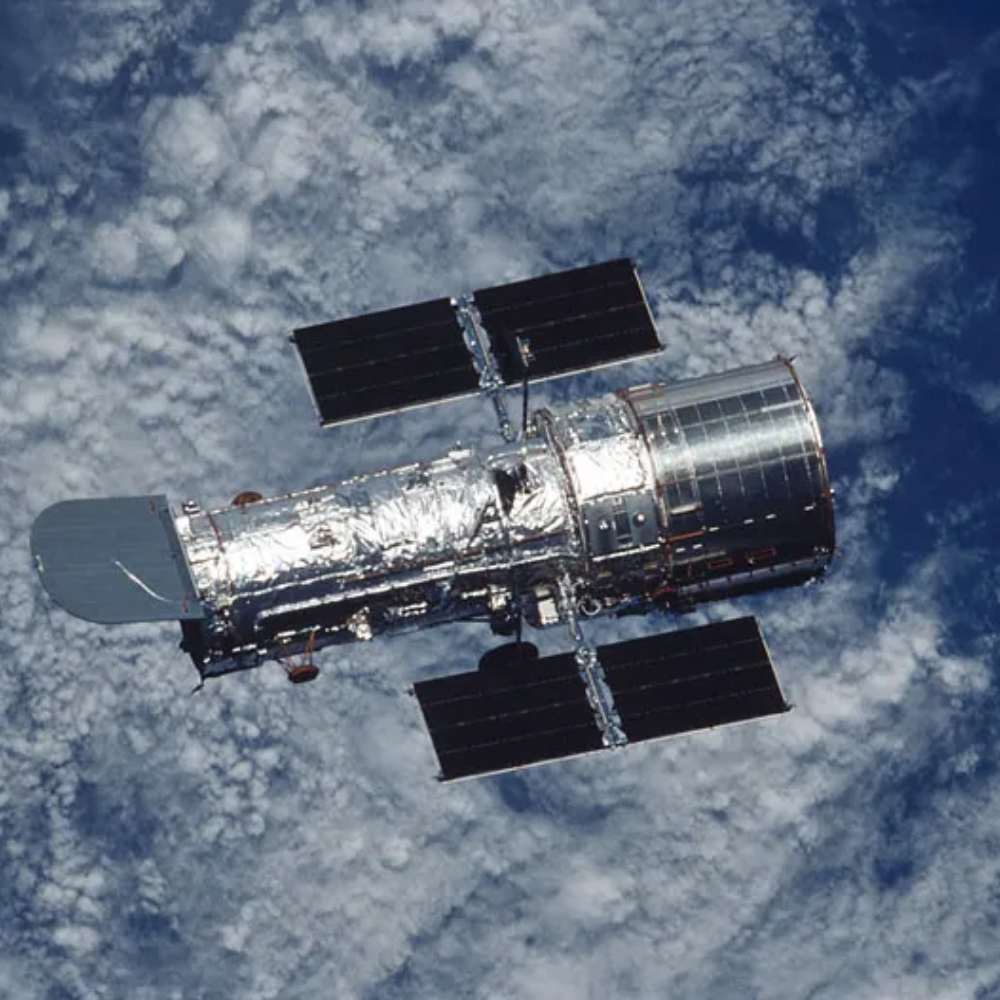 Hubble Space Telescope orbiting above Earth with solar panels extended, capturing deep-space images beyond atmospheric distortion.