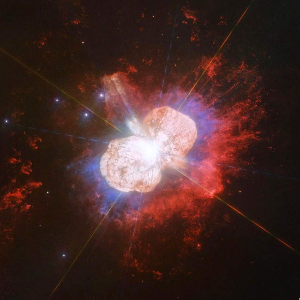High-resolution Hubble image of Eta Carinae showing massive stellar eruption and expanding Homunculus Nebula with bright gas and dust clouds.