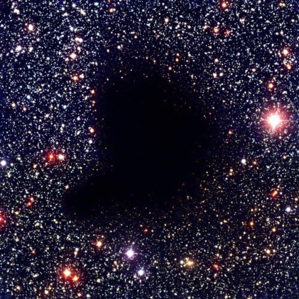 Astronomical image showing the Northern Local Supervoid as a dark, starless region surrounded by dense stellar fields in the local universe.