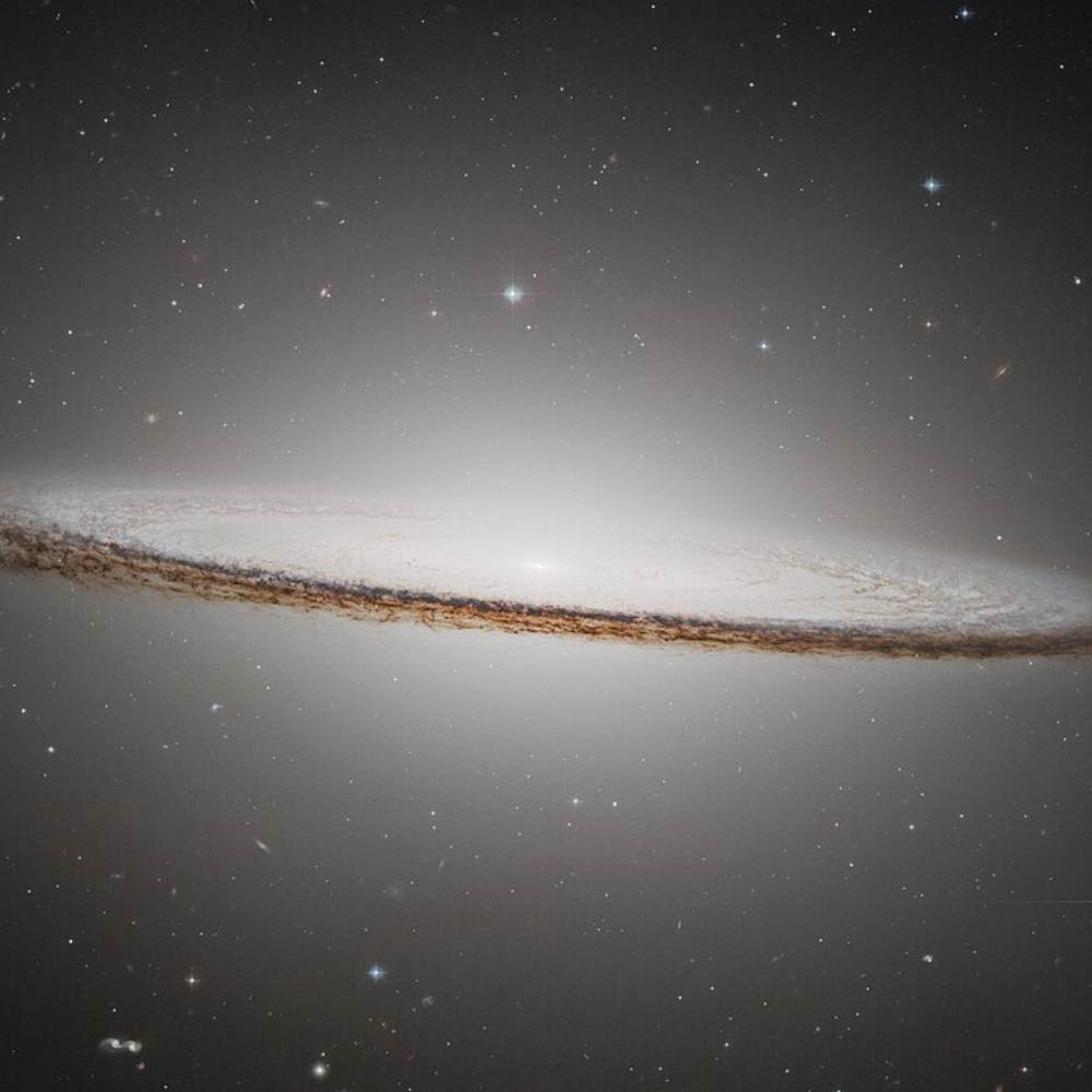Hubble image of the Sombrero Galaxy (Messier 104) showing its bright central bulge and dark dust lane in a nearly edge-on view.