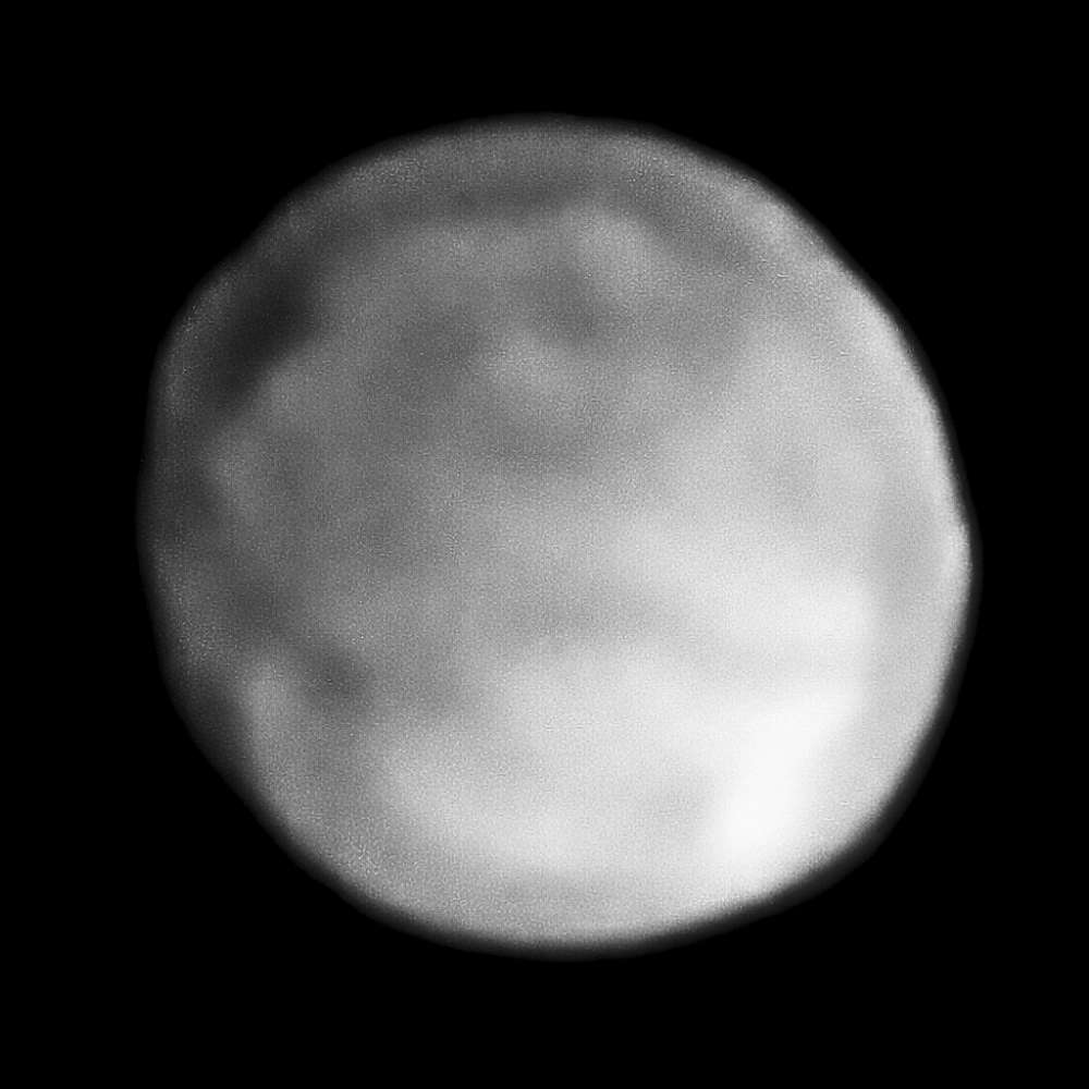 High-resolution image of asteroid 10 Hygiea showing its nearly spherical shape and smooth, dark surface, one of the largest bodies in the main asteroid belt.