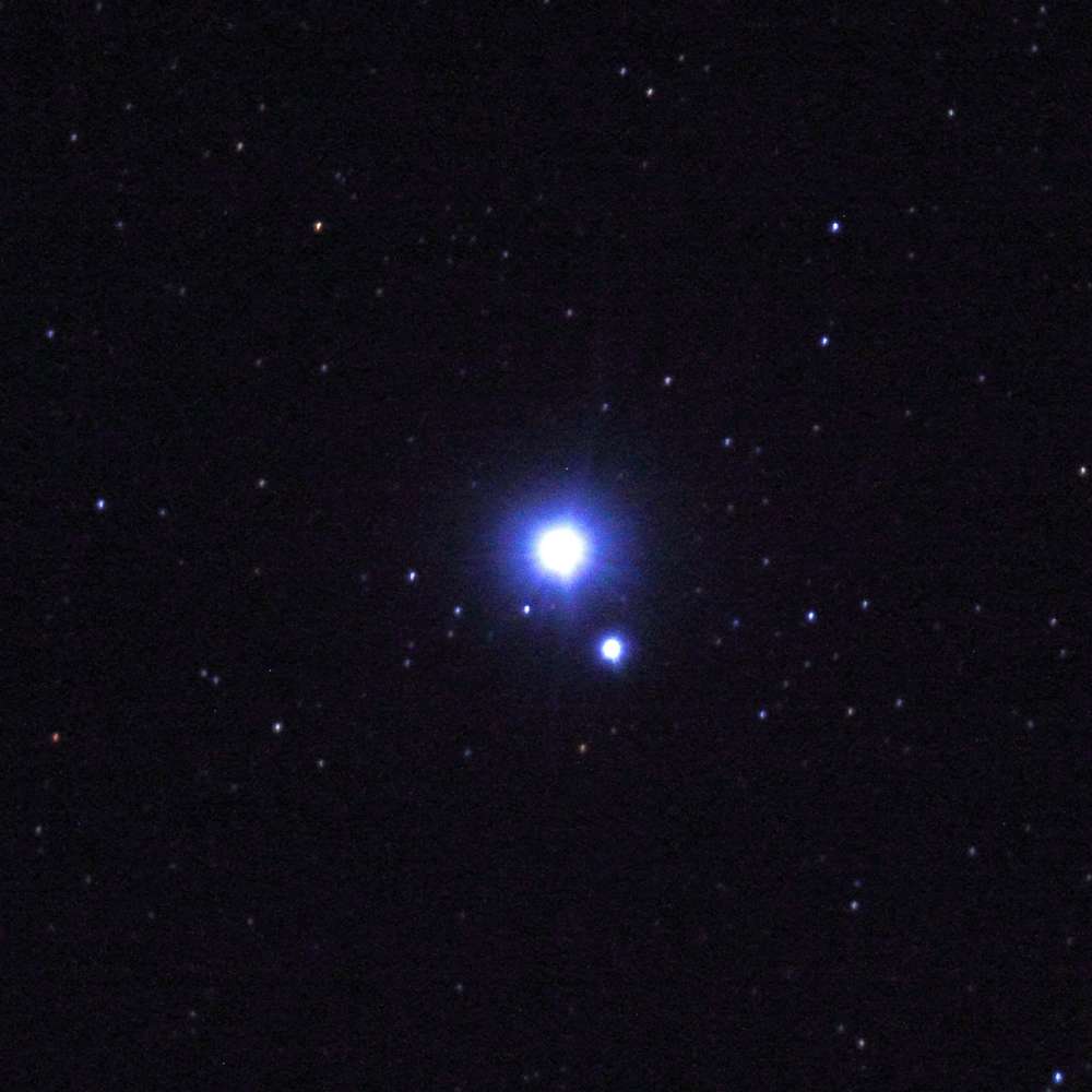 High-resolution star field showing Acrux, the bright multiple-star system in the Crux constellation, with its blue-white components clearly visible.