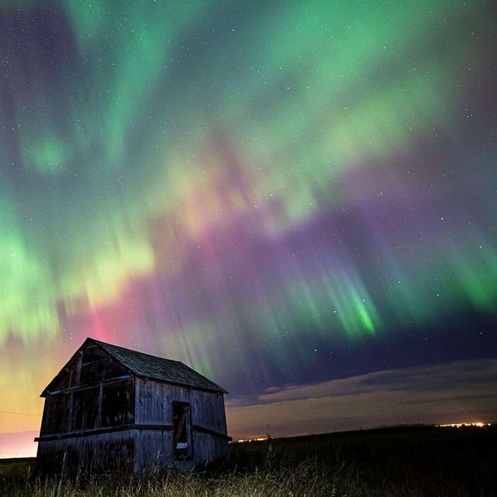 Auroras illuminating the polar night sky as charged solar particles interact with Earth’s magnetic field