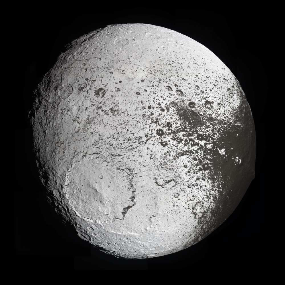 Global view of Iapetus, Saturn’s moon with a dramatic two-tone surface, showing the dark Cassini Regio on one hemisphere and bright icy terrain on the other.
