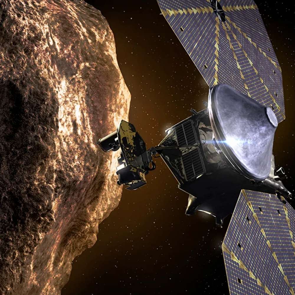 NASA’s Lucy spacecraft performing a close flyby of a rocky asteroid, demonstrating its mission to study Jupiter Trojan asteroids and early Solar System formation.