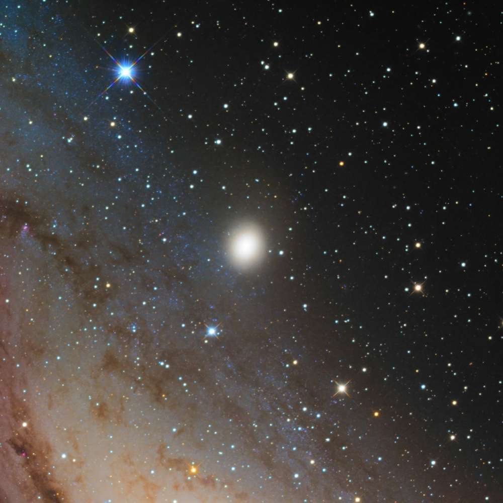 High-resolution image of M32, a compact dwarf elliptical galaxy and close companion of the Andromeda Galaxy, seen against a field of bright foreground stars.