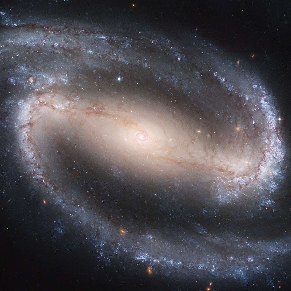 High-resolution Hubble image of NGC 1300, a grand-design barred spiral galaxy with a prominent central bar and well-defined spiral arms.