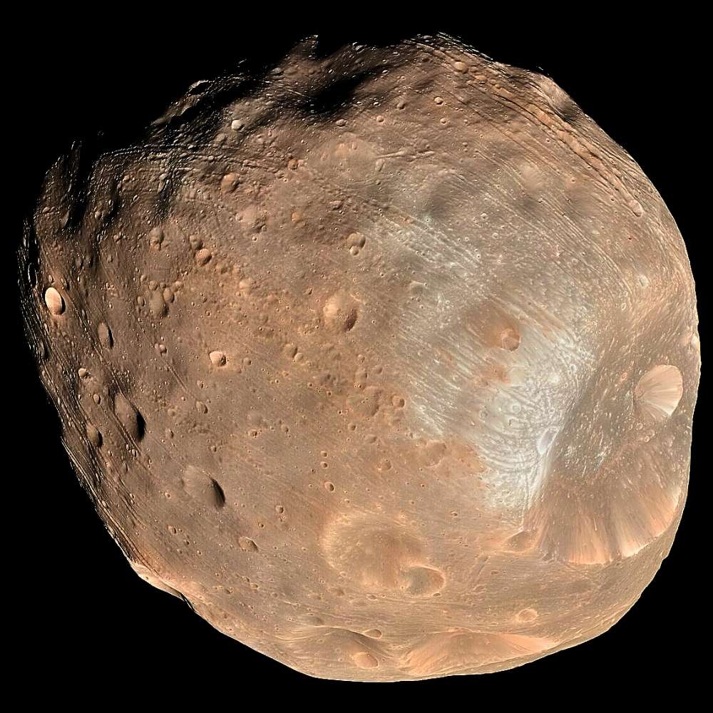 High-resolution image of Phobos, the larger moon of Mars, showing its irregular potato-like shape, surface grooves, and large impact craters including Stickney crater.