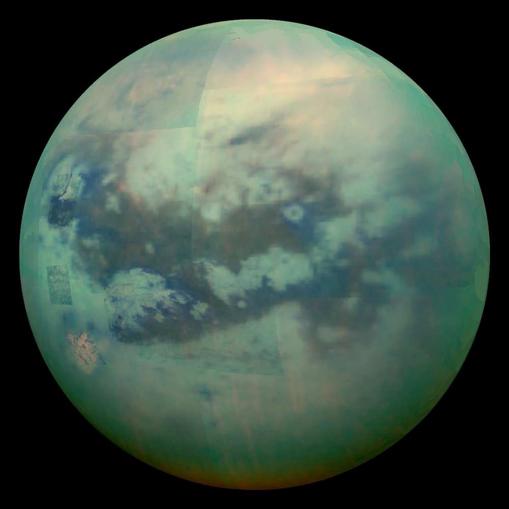 Global view of Titan, Saturn’s largest moon, showing its thick orange-green atmosphere, methane clouds, and hazy surface observed through infrared imaging.