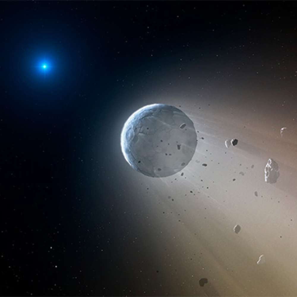 Illustration of Van Maanen’s Star, a white dwarf, illuminating a disintegrating asteroid and surrounding debris as it pulls rocky material into its gravity.
